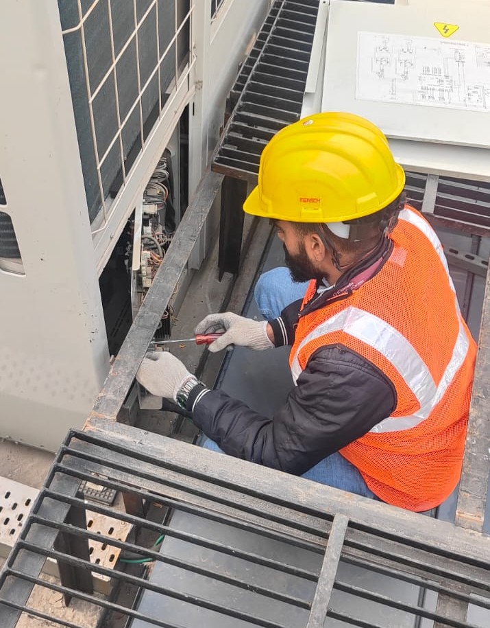 Technician working on HVAC equipment